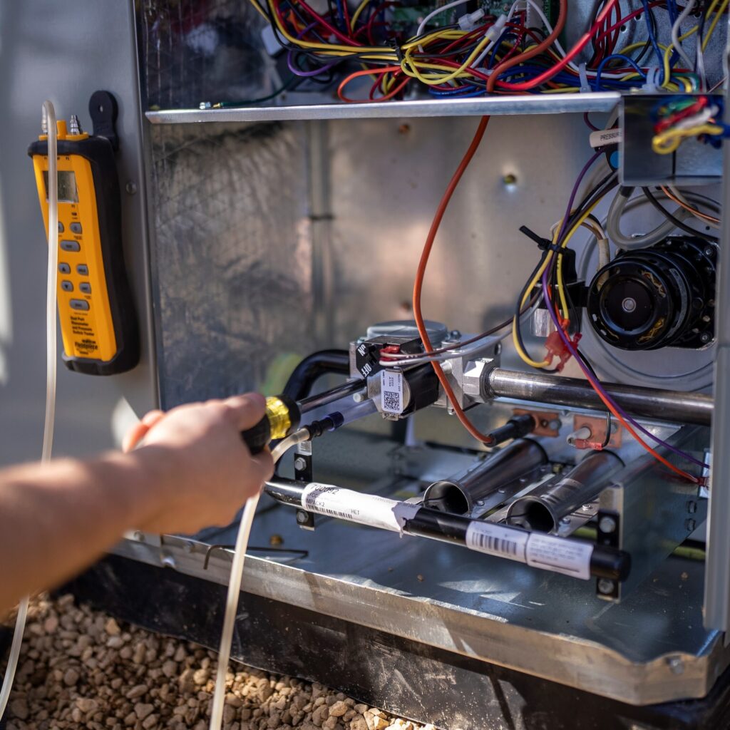 HVAC technicians working on heat pump